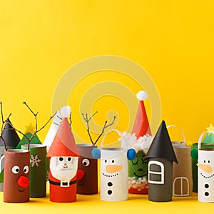 Paper toy Santa, Snowman, Grinch for Xmas party. Easy crafts for kids on yellow background, copy space, die creative idea from