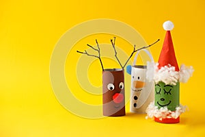 Paper toy Santa, Snowman, Grinch for Xmas party. Easy crafts for kids on yellow background, copy space, die creative idea from