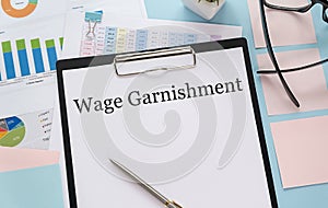 Paper with Wage Garnishment on a table.