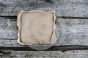 Paper on a wood with rope, burned edges