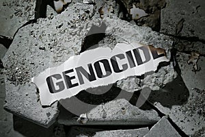 Paper with word Genocide on pieces of concrete, top view