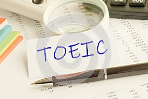 Paper with word TOEIC on a table, concept