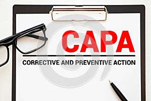 Paper with words CAPA Corrective and Preventive action plans photo