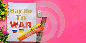 Paper with the words `SAY NO TO WAR` on pink background.