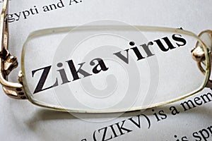 Paper with words zika virus and glasses.