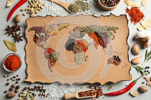 Paper with world map made of different aromatic spices on gray background