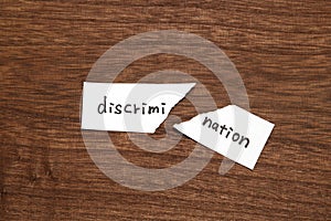 The paper written as discrimination is torn on wood. Concept of abolition of discrimination.