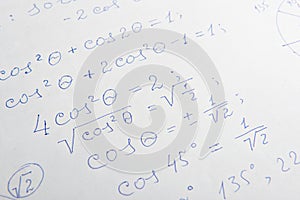 Paper with written mathematical calculations as background, closeup