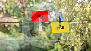 Paper with Yes and No Texts Clipped on a String