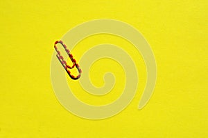Paperclip on bright yellow background