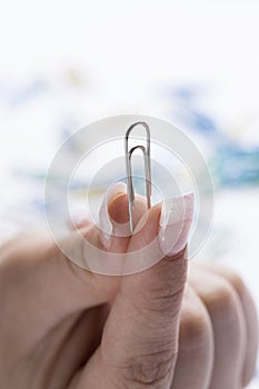 Paperclip in between female hands