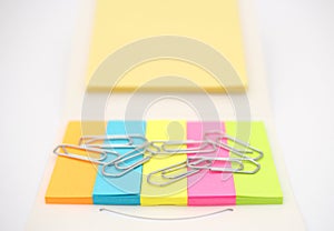 Paperclips with colorful notepads. Office and school equipment