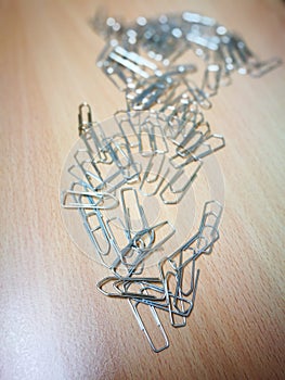 Paperclips lying on a wooden desk