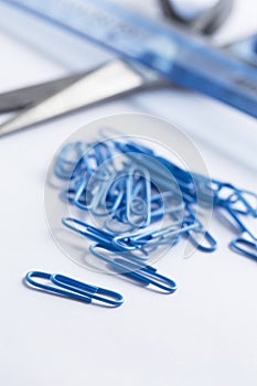 Paperclips scattered on white surface