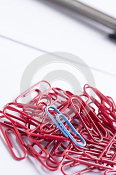 Paperclips scattered on white surface