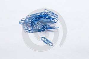 Paperclips scattered on white surface