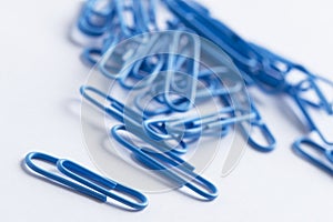 Paperclips scattered on white surface