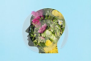 Papercut head with green leaves and flowers. Mental health, emotional wellness, contented emotions, self care, psychology, green