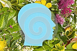 Papercut head with green leaves and flowers. Mental health, emotional wellness, contented emotions, self care, psychology, green