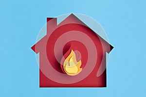 Papercut house with fire inside. Home insurance, security, safety, damage, accident prevention