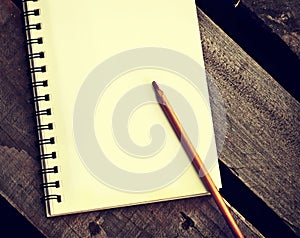 Papers in a copybook with pen on wooden table