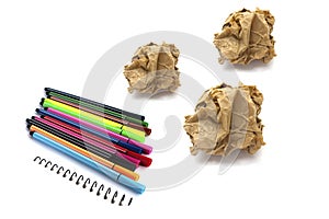 Papers crumple ball and color pen on white background