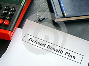 Papers with defined benefit plan and calculator. photo