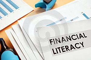 Papers about financial literacy with business graphs