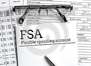 Papers with flexible spending account FSA on a table