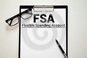 Papers with flexible spending account FSA on a table, business concept