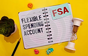 Papers with flexible spending account FSA on a table, business concept.