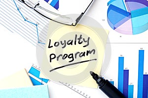 Papers with graphs and Loyalty Program concept.