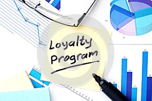 Papers with graphs and Loyalty Program concept. photo