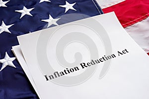 Papers with the Inflation Reduction Act and US flag. photo