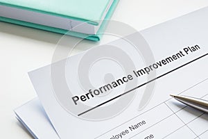 Papers about performance improvement plan and pen.