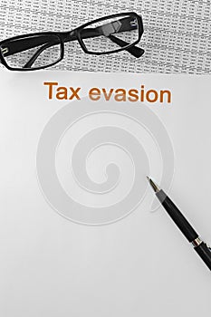 Papers about tax evasion on a desk