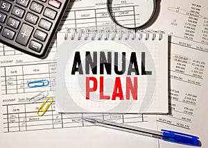 Papers with text, ANNUAL PLAN on table, business concept