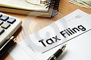 Papers with title Tax filing on an office desk.