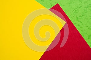 Papers yellow red green chape background. photo