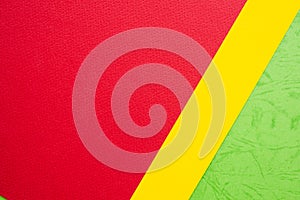 Papers yellow red green chape background. photo