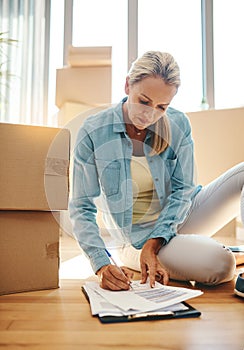 Paperwork, boxes and woman on the floor in apartment for growth on investment in mortgage. New house, document and sign