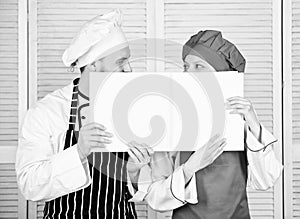 Paperwork. Chef and prep cook holding empty account book. Cook and helper performing book keeping. Couple of man and