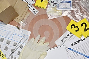 Paperwork during crime scene investigation process in csi laboratory. Evidence labels with fingerprint applicant and many