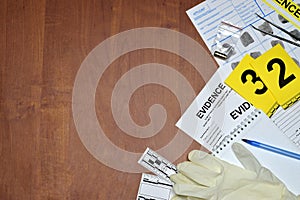 Paperwork during crime scene investigation process in csi laboratory. Evidence labels with fingerprint applicant and rubber gloves