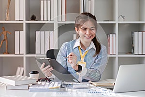 Paperwork. Happy smiling asian business woman in formal wear sitting at wooden desk in modern office and reading report