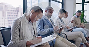 Paperwork, job candidates and people in waiting room writing resume information at recruitment agency. Human resources