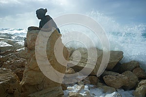 Paphos harbour statue of woman called Sol Alter in Cyprus.