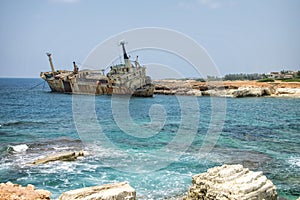 Paphos. Shipwreck. The ship crashed on the coastal rocks at the shore of Mediterranean sea. Tourist attractions of Cyprus