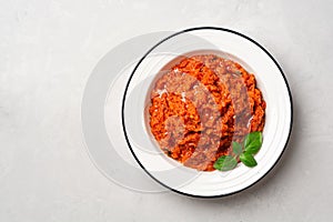 Pappa al Pomodoro. Tuscan bread soup with tomatoes, olive oil and basil in plate on concrete background. Traditional italian dish