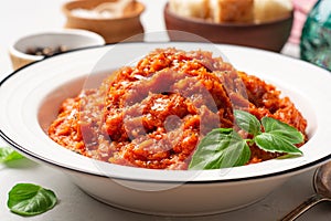 Pappa al Pomodoro. Tuscan bread soup with tomatoes, olive oil and basil in plate on concrete background. Traditional italian dish